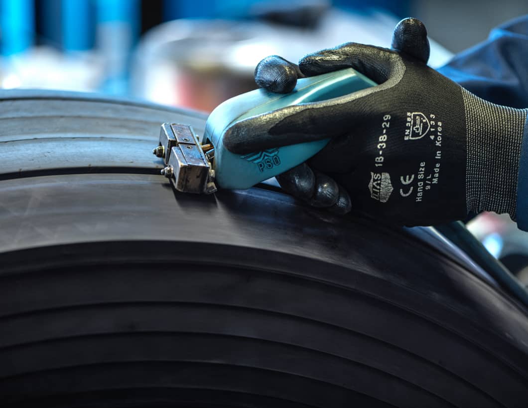 Goodyear tyre expert regrooving a truck tyre for additional tread depth